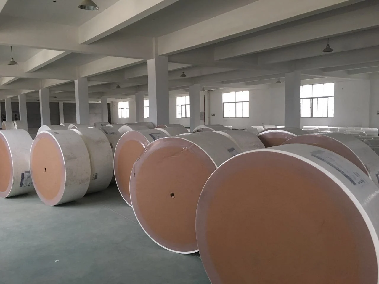 Warehouse storage of material rolls from the supplied company photos